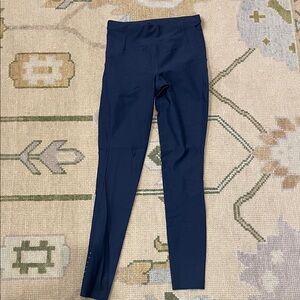 Lululemon Navy High-Waist Active Leggings with diagonal detail at the thighs.